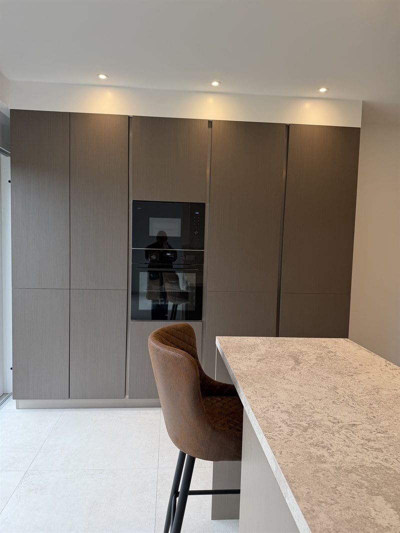 Cuisine fermée de style moderne beige et gris à Petit Enghien | Raison Home - 4